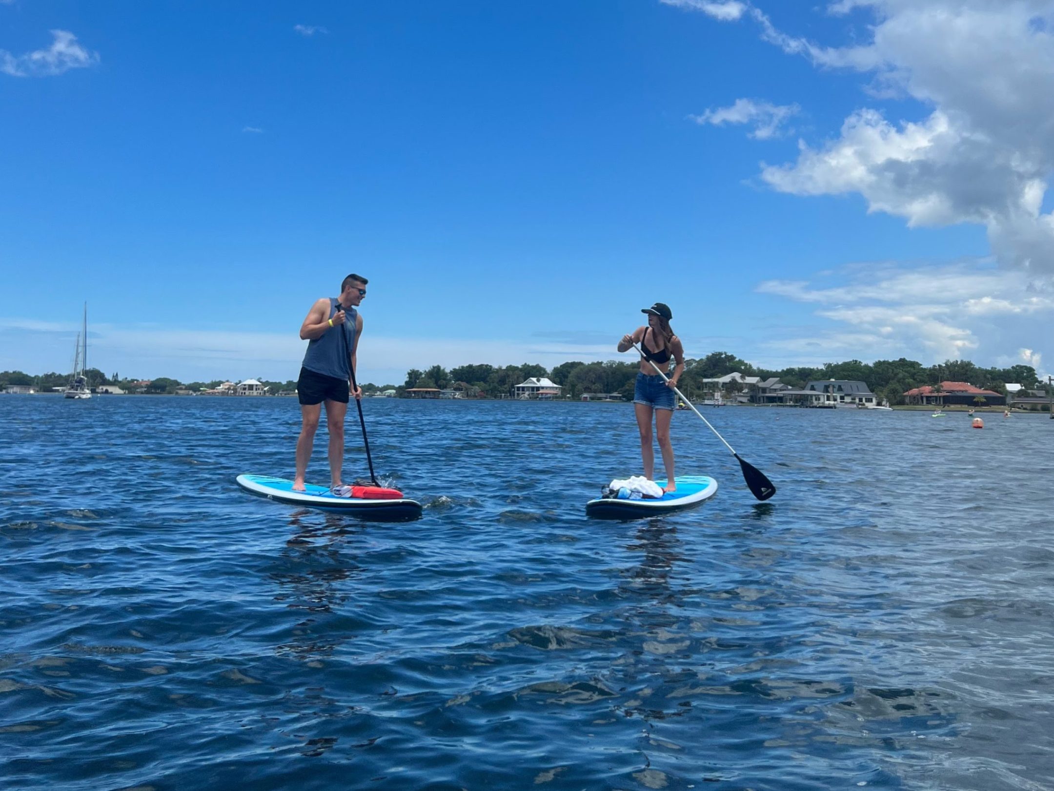 Cute couple having fun on a paddleboard rental from Paddles Outdoor Rentals in Crystal River, Florida